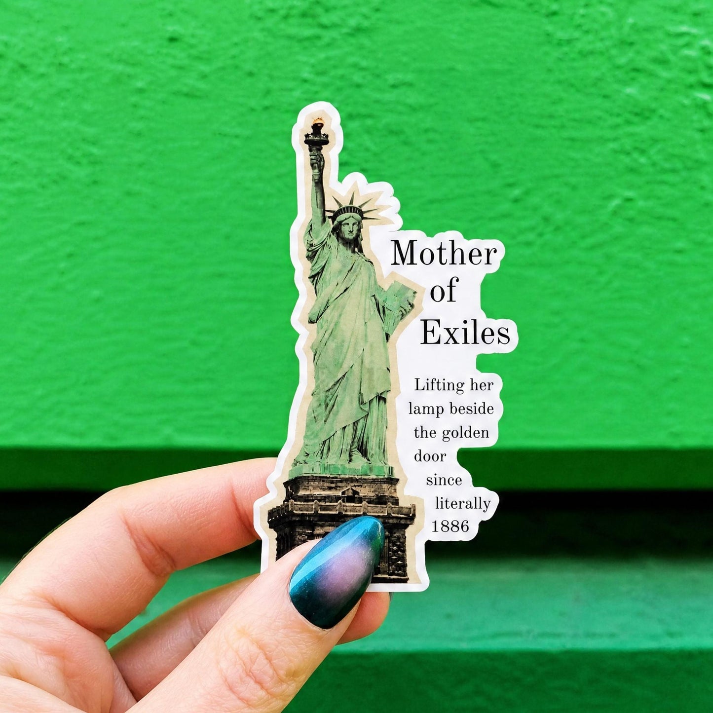 A die-cut sticker featuring a green Statue of Liberty illustration and the text 'Mother of Exiles' and 'Lifting her lamp beside the golden door since literally 1886.'